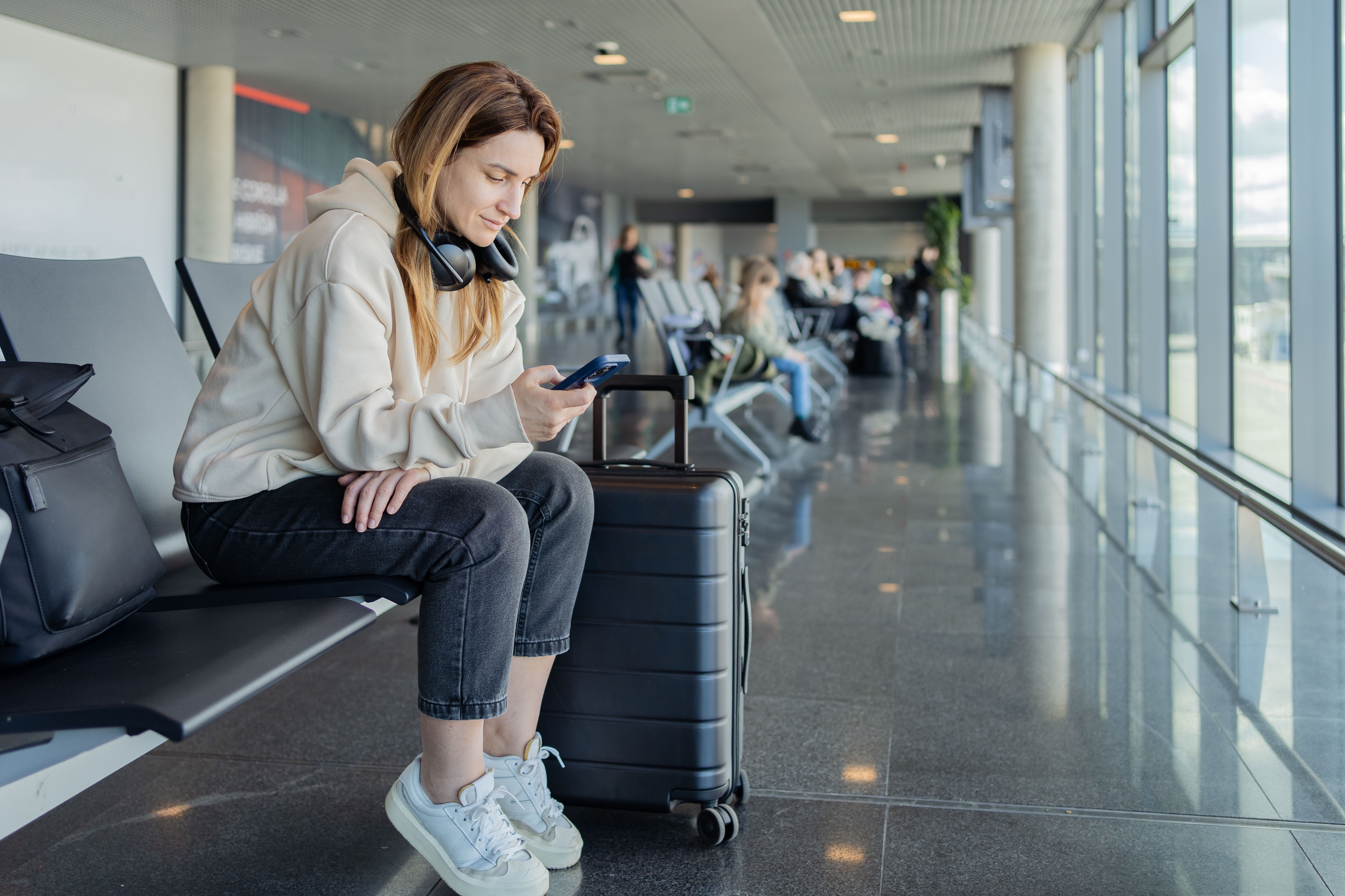 Woman sitting and waiting at an airport.