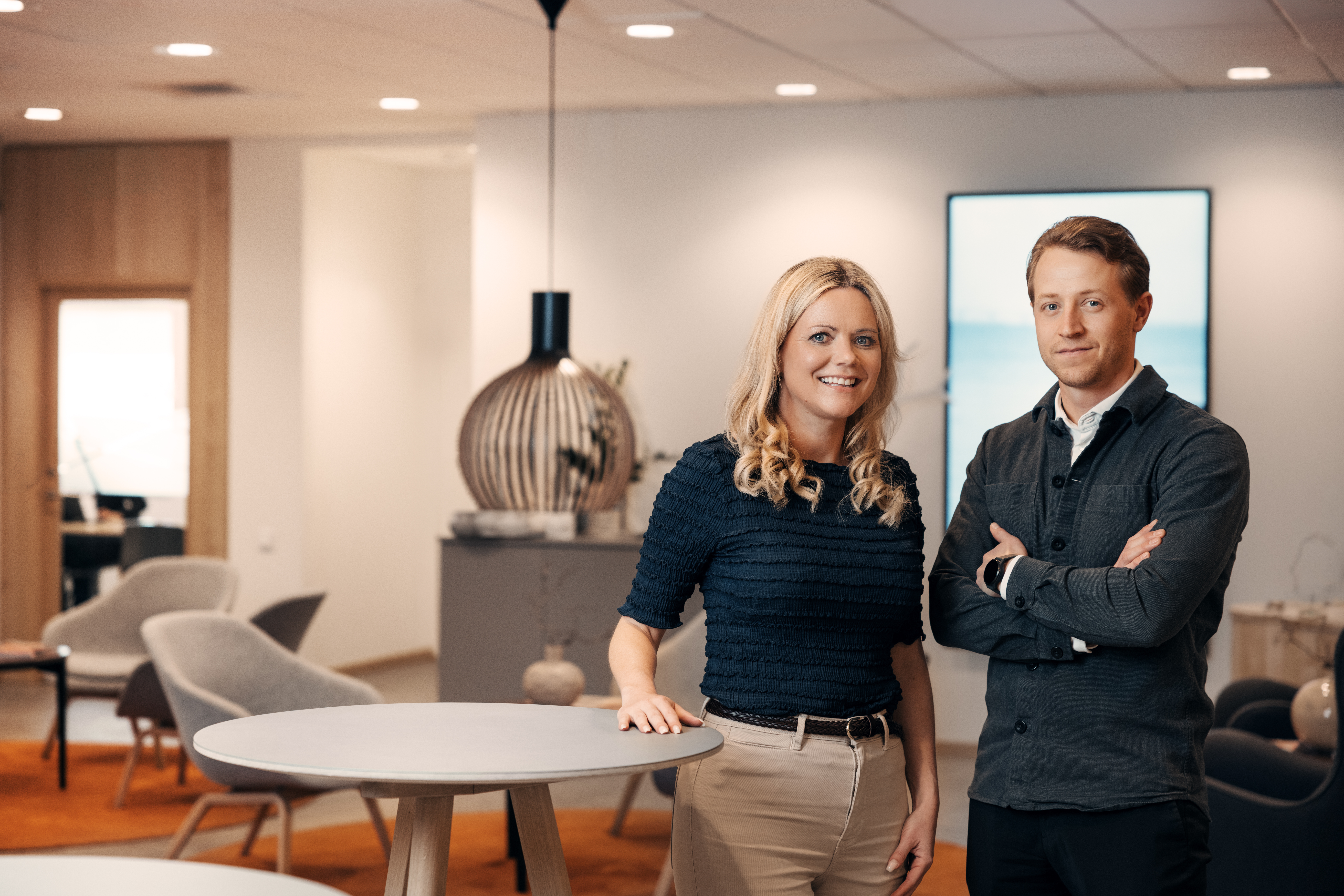 Two people standing in an office.